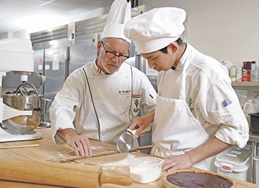 Photo of chefs in a kitchen. Links to Gifts by Estate Note
